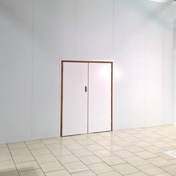 A white fire rated double personnel door with a digital lock keypad and a vertical locking bolt
